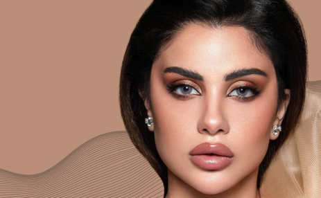 Close-up of a woman with makeup on a beige background