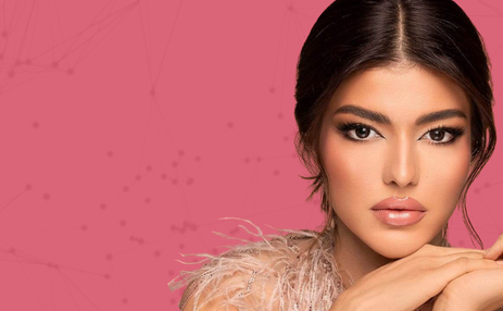Woman with makeup against a pink background